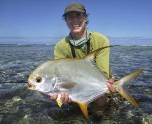jonathan olch holding a permit fish in the ocean